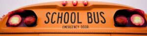 School bus flashing its lights as it let's children off