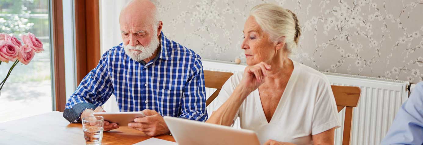 Elderly husband and wife are on computer figuring out Deductibility of CPP Disability Benefits from Past Loss of Income