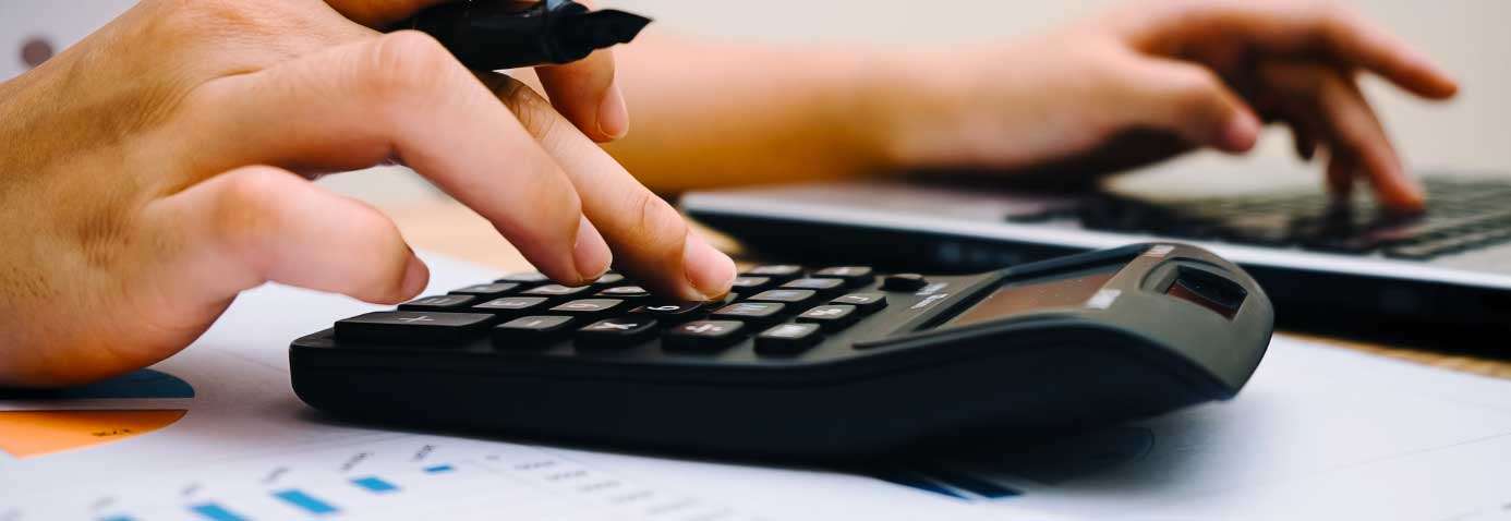 Person working out numbers on a calculator