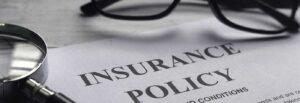 Picture of an insurance policy with a magnifying glass and glasses