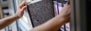 Lawyer pulling down a case file.