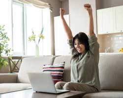 Photo of an image of a woman celebrating victory on a computer