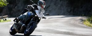 Man Riding down the highway on his motorcycle.