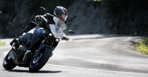 Man Riding down the highway on his motorcycle.