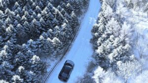 A car on a snow covered winding Maritime Road