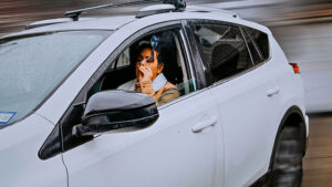Woman smoking cannabis in her car.
