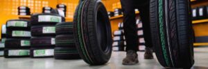 Tires in a shop being moved around by a tire mechanic