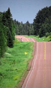 An Atlantic Canadian highway surrounded by beautiful green trees.