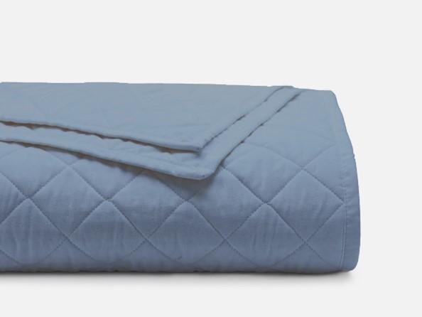 a blue blanket on a white surface