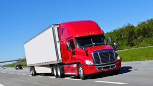 Red transport truck on a maritime highway